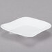 A bright white porcelain square plate with a small rim.