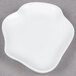 A 10 Strawberry Street bright white porcelain plate with a small white shape on it.