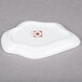 A white porcelain plate with a red logo on it.