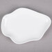 A 10 Strawberry Street bright white porcelain plate with a small shape on it.
