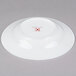A white 10 Strawberry Street bone china wide rim soup bowl with a red logo.