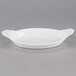 A 10 Strawberry Street white porcelain oval rarebit dish with a handle.