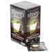 A box of Steep By Bigelow Organic English Breakfast Tea Bags on a table with a white cup and green leaves on it.