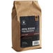 A brown bag of Crown Beverages Royal Reserve Guatemalan Whole Bean Coffee with a black label.