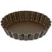 A brown Gobel fluted tart pan with a removable bottom.