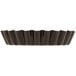 A black fluted Gobel tart pan with a removable bottom.