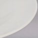A close up of a Tuxton eggshell china pasta bowl with a white surface.