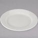 A Tuxton Reno ivory china plate with a wide rim on a white background.