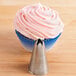 A cupcake with pink frosting piped on top using an Ateco closed star piping tip.