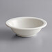 A Tuxton Nevada narrow rim china bowl in white on a gray surface.