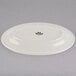 An eggshell white oval china platter with a wide black rim.