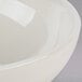 A white Tuxton Reno china bowl with a round rim.
