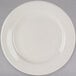 A Tuxton Reno ivory china plate with a wide white rim on a white background.