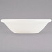 A white rectangular Tuxton China bowl with a black border.