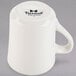 A white Tuxton Tiara mug with a handle.