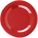A white Carlisle melamine plate with a red rim.