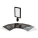 A black Lancaster Table & Seating stanchion sign frame with clear covers holding a white sign.