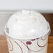 A Solo Ultra Clear plastic dome lid with a cup of whipped cream on top.
