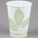 A white paper cup with green leaves on it.