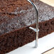 A chocolate cake with a metal bar on top.