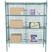 A Regency green metal wire security cage with boxes on shelves.