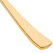 A close up of a Fineline gold plastic spoon with a handle.