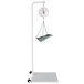A white Cardinal Detecto hanging scale with a stand.