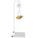 A Cardinal Detecto hanging scale with a metal scoop full of oranges and a basket of oranges.