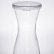 A clear plastic carafe with a white lid.