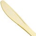 A close up of a Fineline gold plastic knife with a long blade.