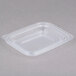 A clear plastic Genpak rectangular lid on a gray surface.