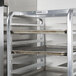 A Channel heavy-duty aluminum sheet pan rack holding trays.