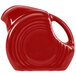 A red Fiesta mini creamer pitcher with a handle.