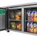A Turbo Air undercounter refrigerator with a door open and a variety of fruit inside.