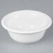A Tuxton white China pot pie bowl on a gray surface.