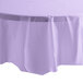 A table covered with a Creative Converting Luscious Lavender purple plastic table cover.