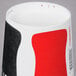 A Solo poly paper cold cup with a red and black Coca-Cola design.