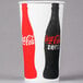 A white and red Solo paper cold cup with a black and red Coca Cola bottle on it.