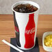 A Solo Coke paper cold cup filled with ice and soda.