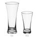 Two Acopa flared pilsner glasses on a white background.