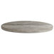 A Grosfillex VanGuard round wooden table top with a grey finish.
