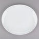 A Tuxton bright white oval china platter with a white rim.