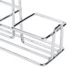 A chrome metal round top rack with three compartments for American Metalcraft salt and pepper shakers.