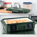A green Cambro Ultra Pan Carrier with food inside.