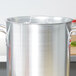 A Vollrath Arkadia stainless steel pot cover with a handle.