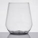 A clear plastic stemless wine goblet on a white background.