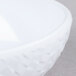 A close up of a white GET Coralline triangle melamine bowl with a white rim.