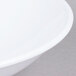 A close up of a white Milano melamine bowl with a white rim.