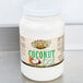 A white bottle of Golden Barrel Coconut Oil with a white lid.