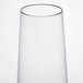 A clear plastic stemless flute with a white background.
